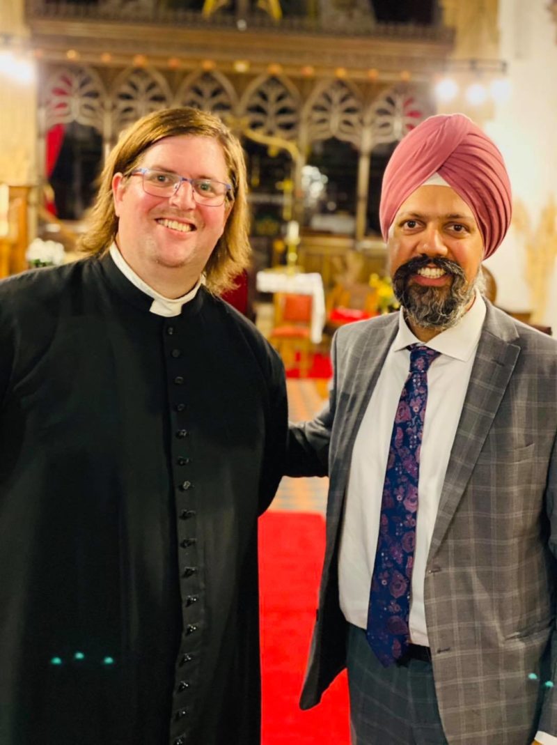 Tan Dhesi with a Priest