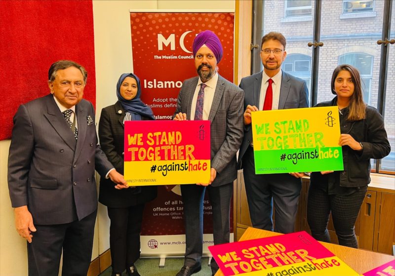 Tan Dhesi, Afzal Khan, Amnesty UK, and the Muslim Council of Britain holding We Stand Together #AgainstHate signs 