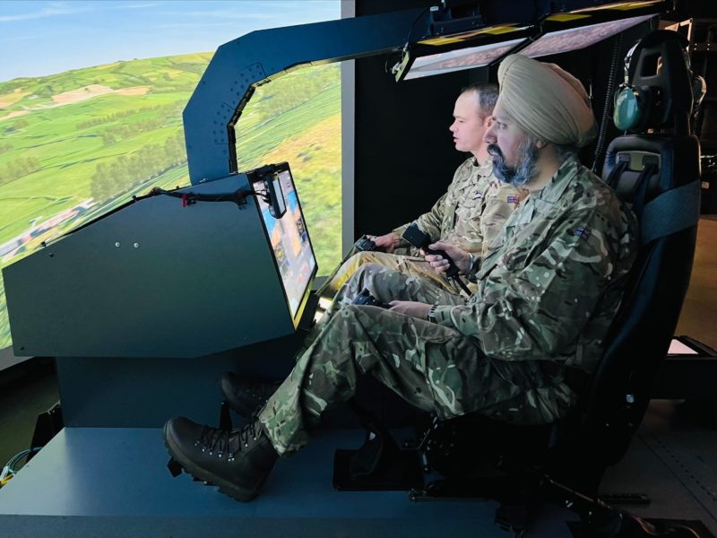 Tan in a simulator cockpit